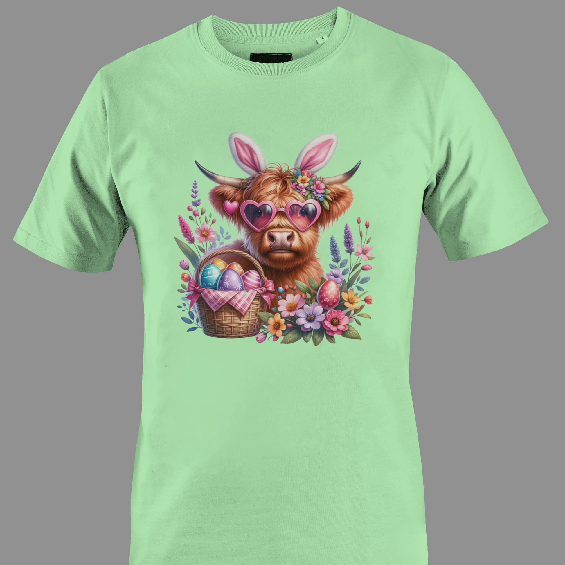 Light green t-shirt with a highland cow wearing heart glasses with an easter egg basket and flowers