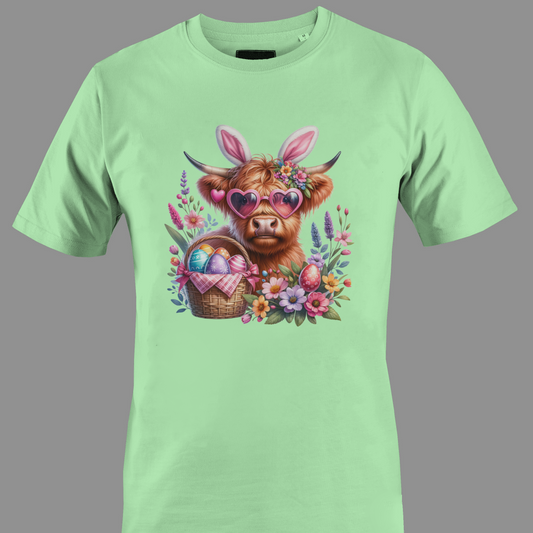 Light green t-shirt with a highland cow wearing heart glasses with an easter egg basket and flowers