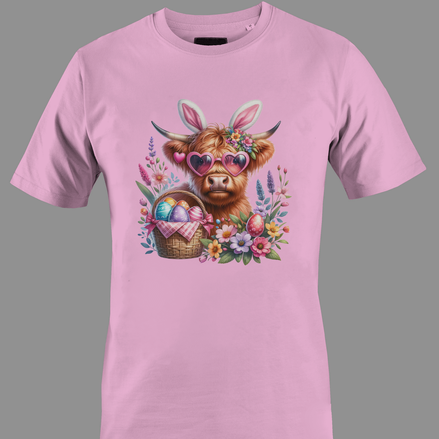 Light pink t-shirt with a highland cow wearing heart glasses with an easter egg basket and flowers