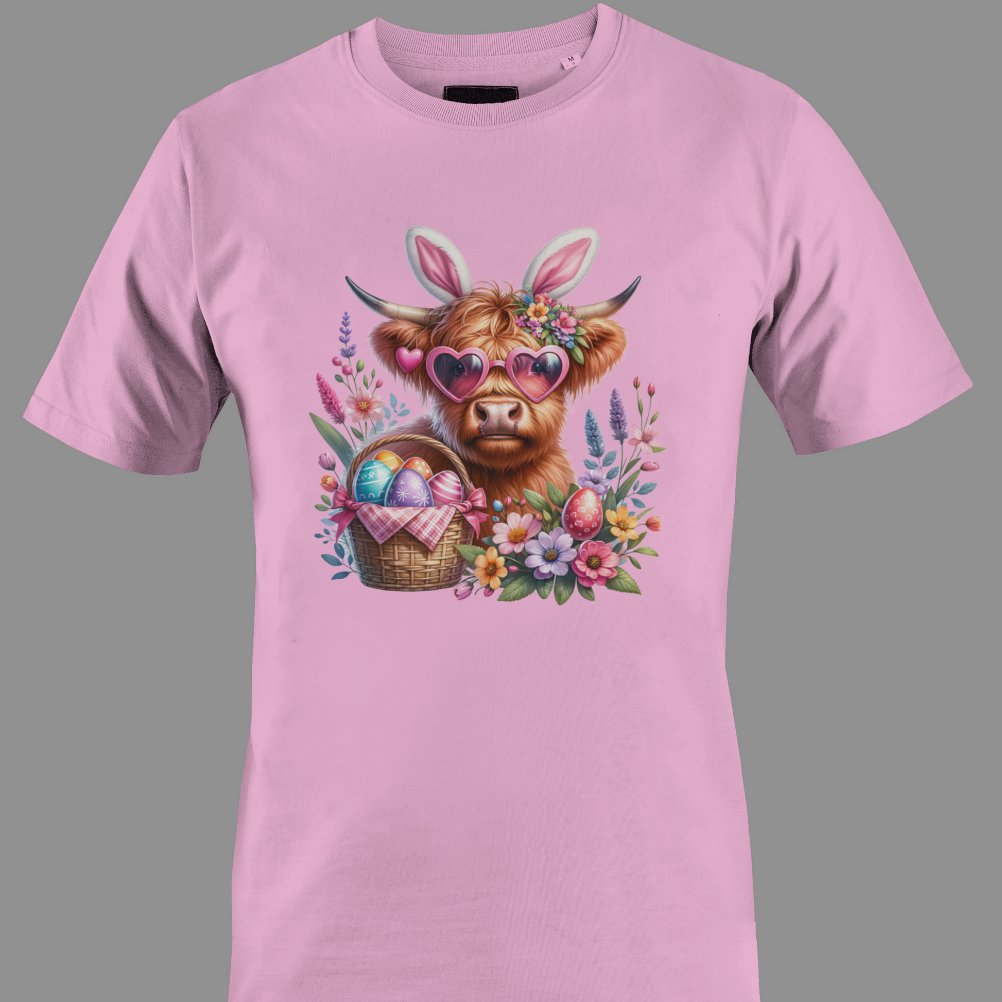Light pink t-shirt with a highland cow wearing heart glasses with an easter egg basket and flowers