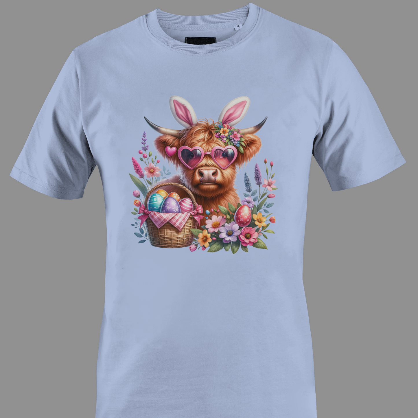 Light purple t-shirt with a highland cow wearing heart glasses with an easter egg basket and flowers