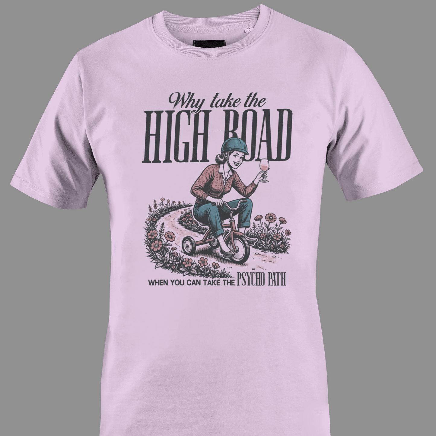 Light pink t-shirt with Lady on tricycle and text high road and psycho path