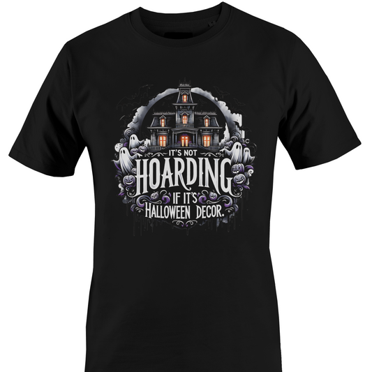 A black short-sleeve crewneck t-shirt featuring a Halloween-themed graphic print on the front. The graphic shows a haunted house, ghosts, and purple flowers with the text 'IT'S NOT HOARDING IF IT'S HALLOWEEN DECOR' by Monkey's Creations.