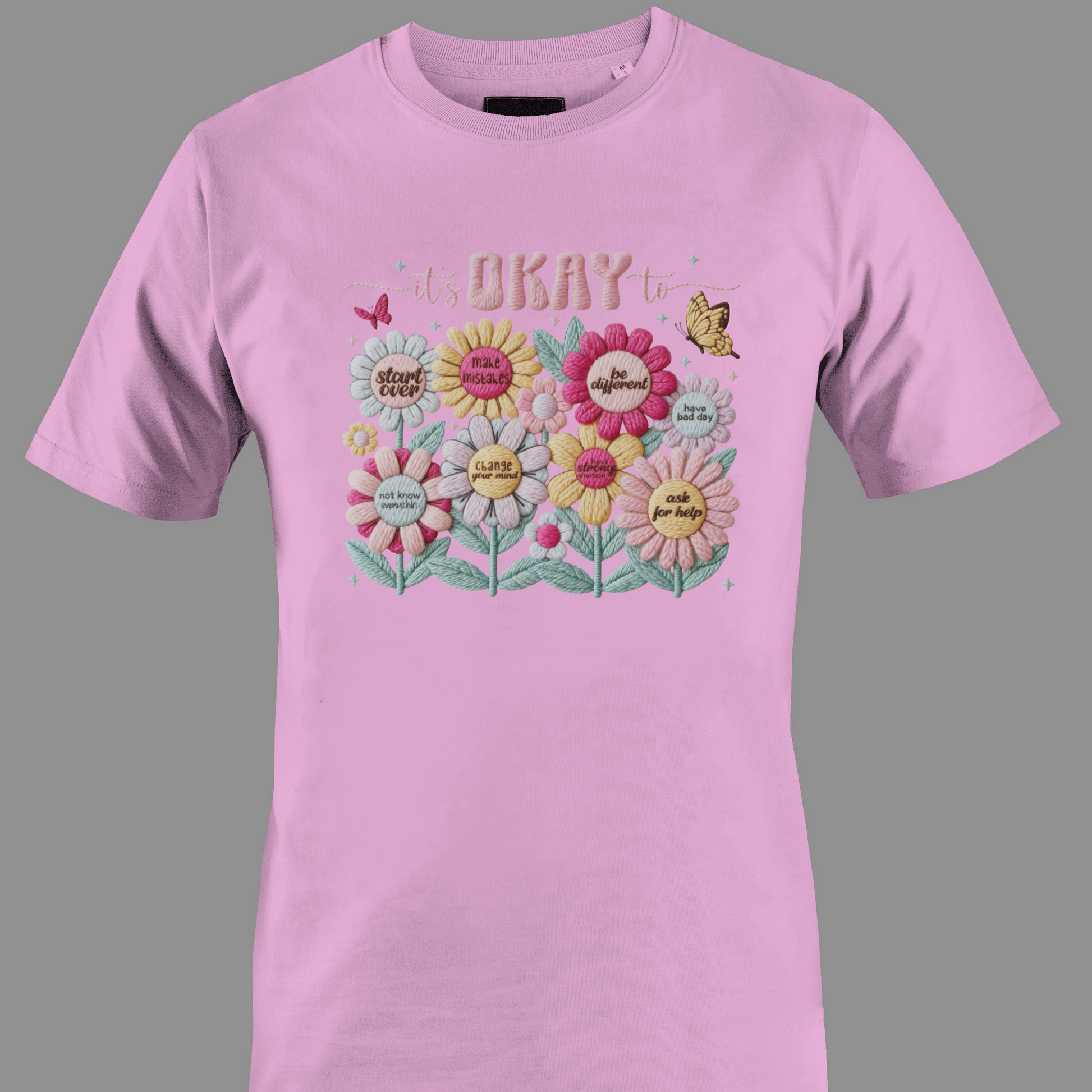 Light pink t-shirt with floral design and text It's ok to
