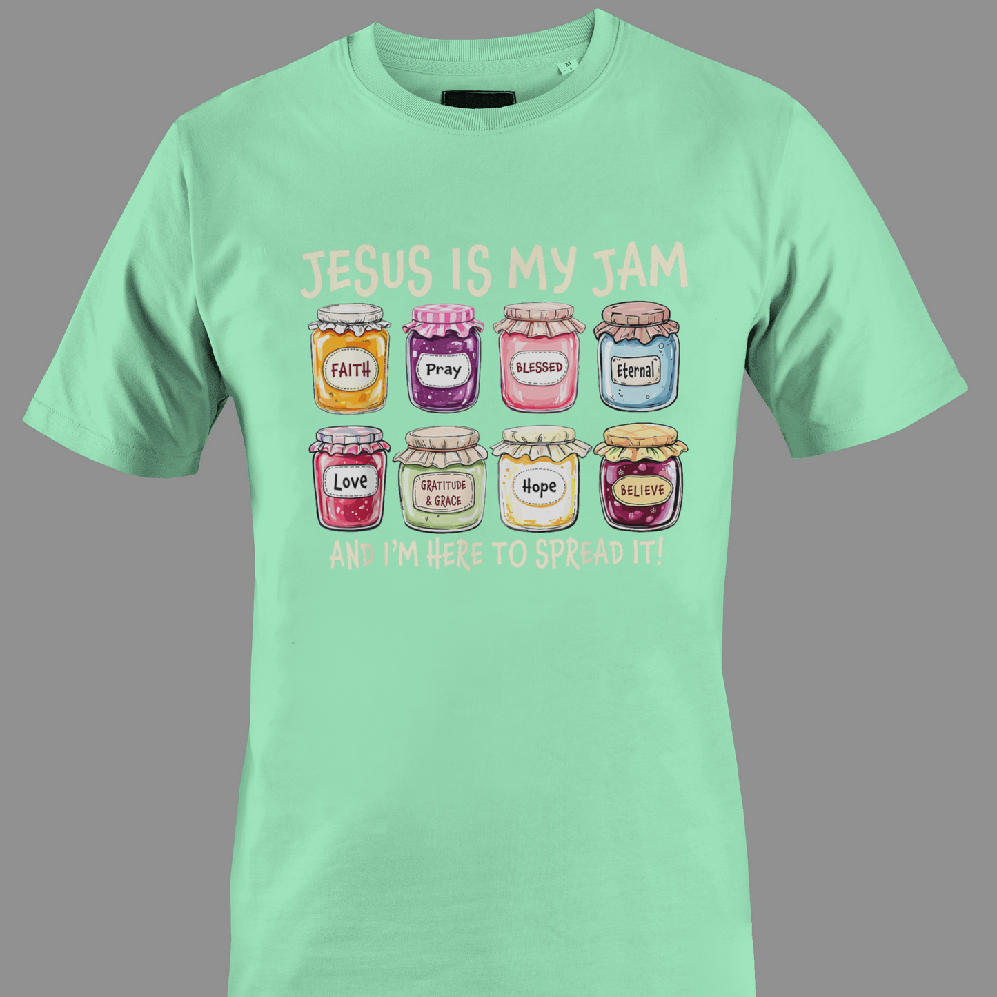 Light green t-shirt with colorful jam jars graphic and text Jesus is my jam