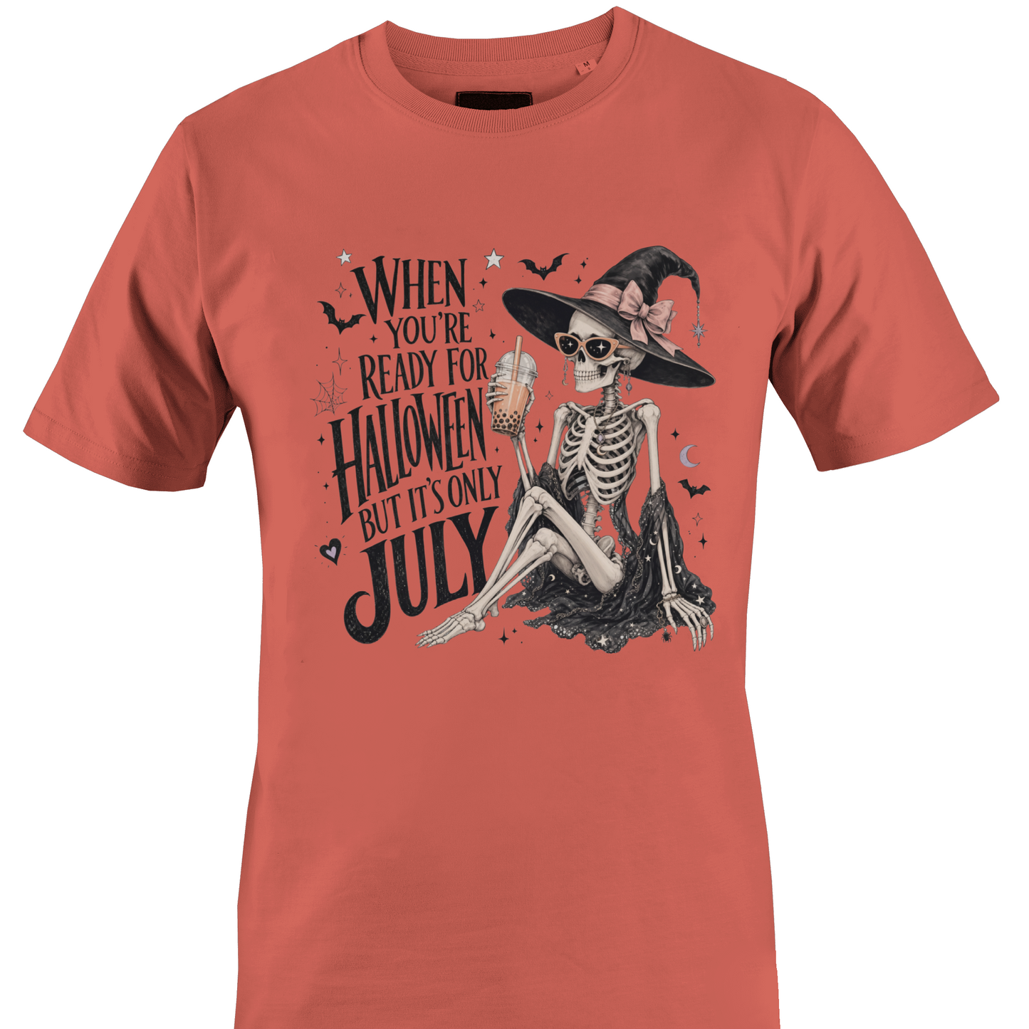 Coral t-shirt with skeleton witch design and text "when you're ready for Halloween but it's only July" by Monkey's Creations. 