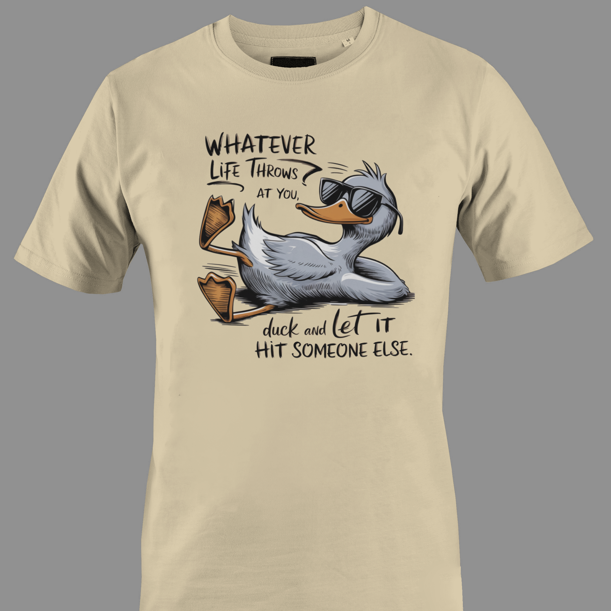 Beige t-shirt with a cartoon duck graphic and text whatever life throws at you