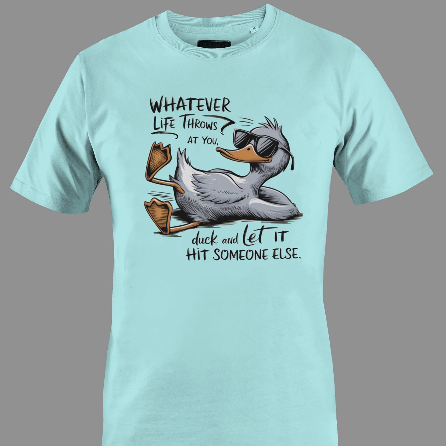 Light blue t-shirt with a cartoon duck graphic and text whatever life throws at you