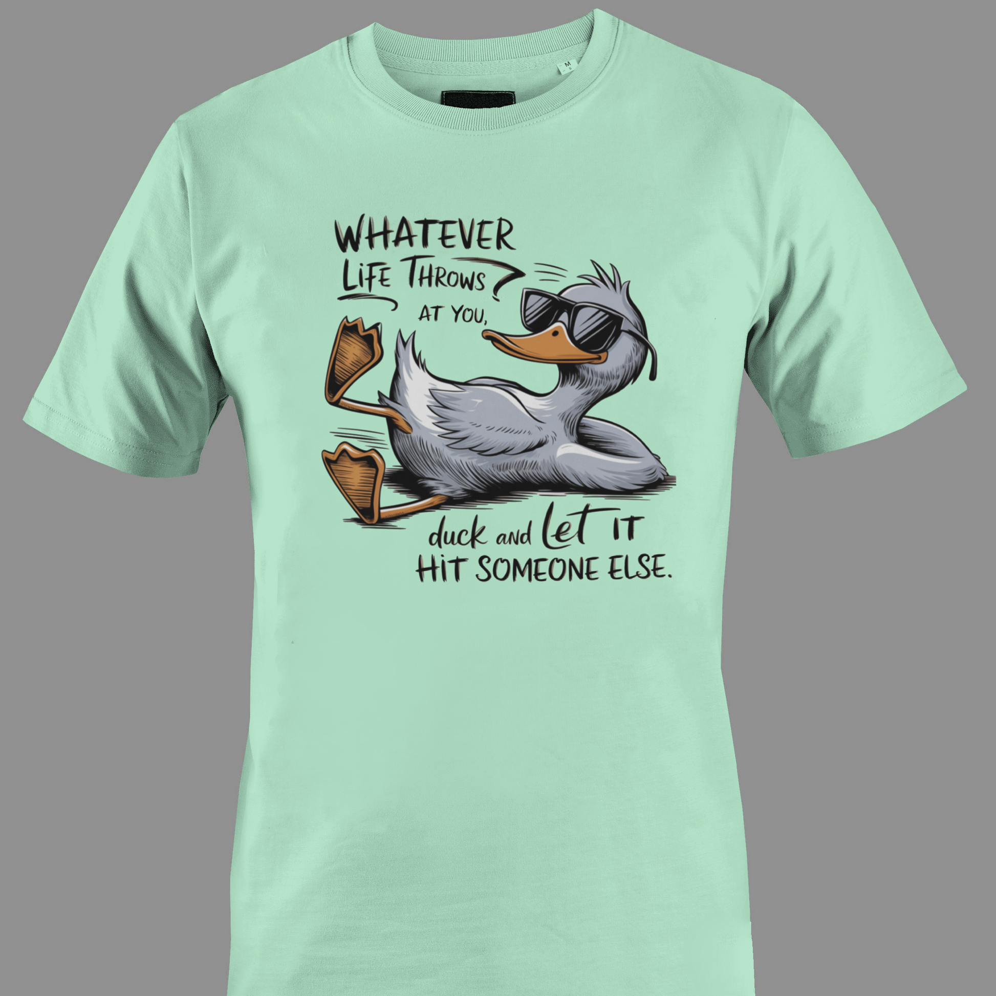 Light green t-shirt with a cartoon duck graphic and text whatever life throws at you