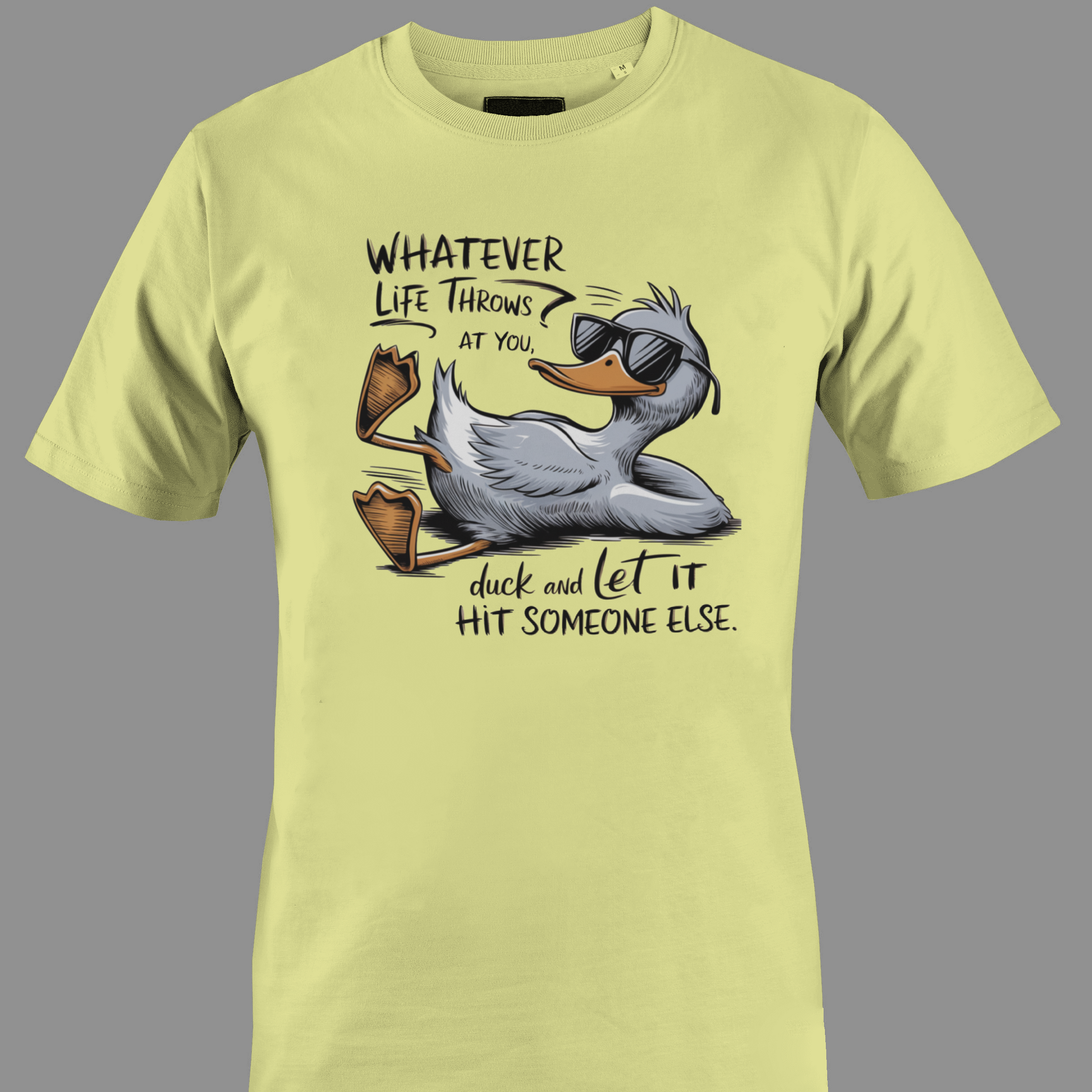 Light yellow t-shirt with a cartoon duck graphic and text whatever life throws at you