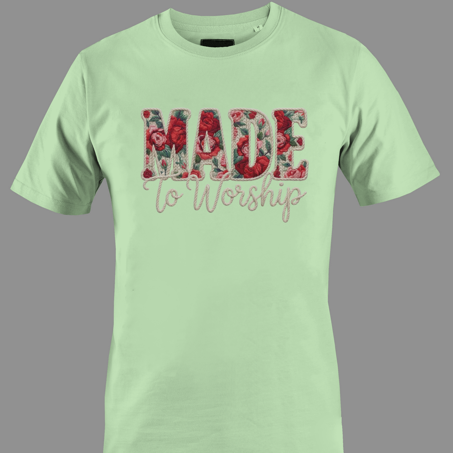 Light green t-shirt with 'Made to Worship' text in a floral design 