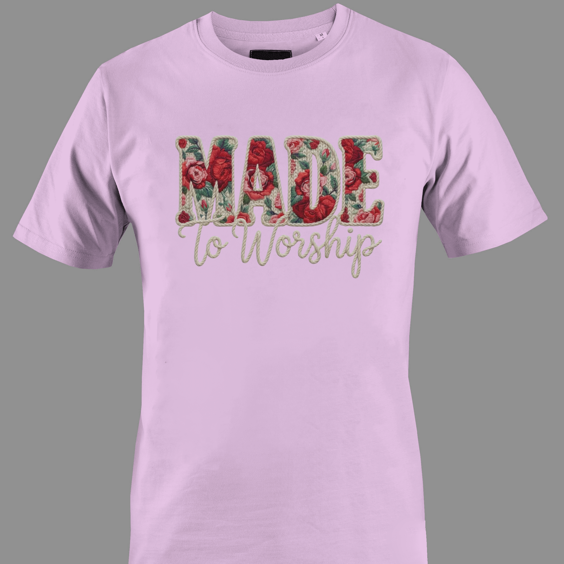 Light pink t-shirt with 'Made to Worship' text in a floral design 