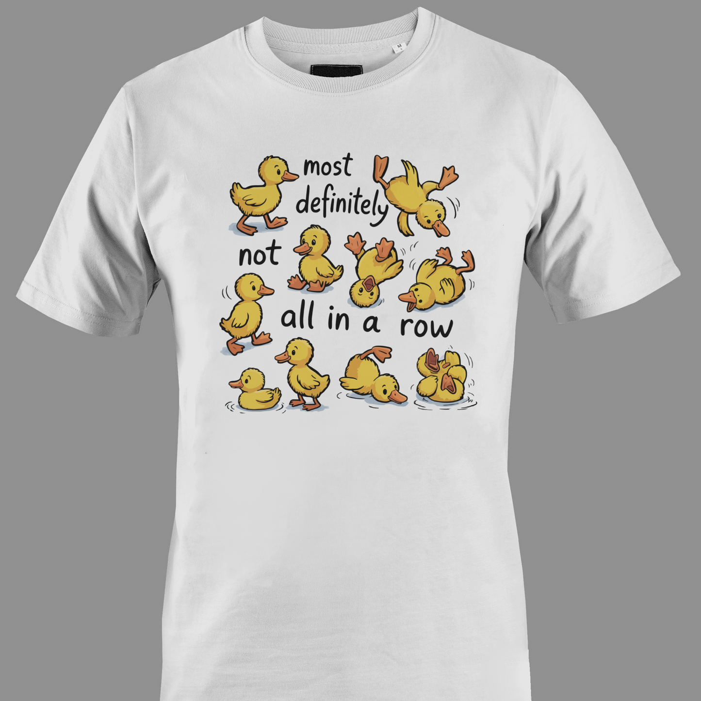 White t-shirt with yellow ducklings and text most definitely not all in a row