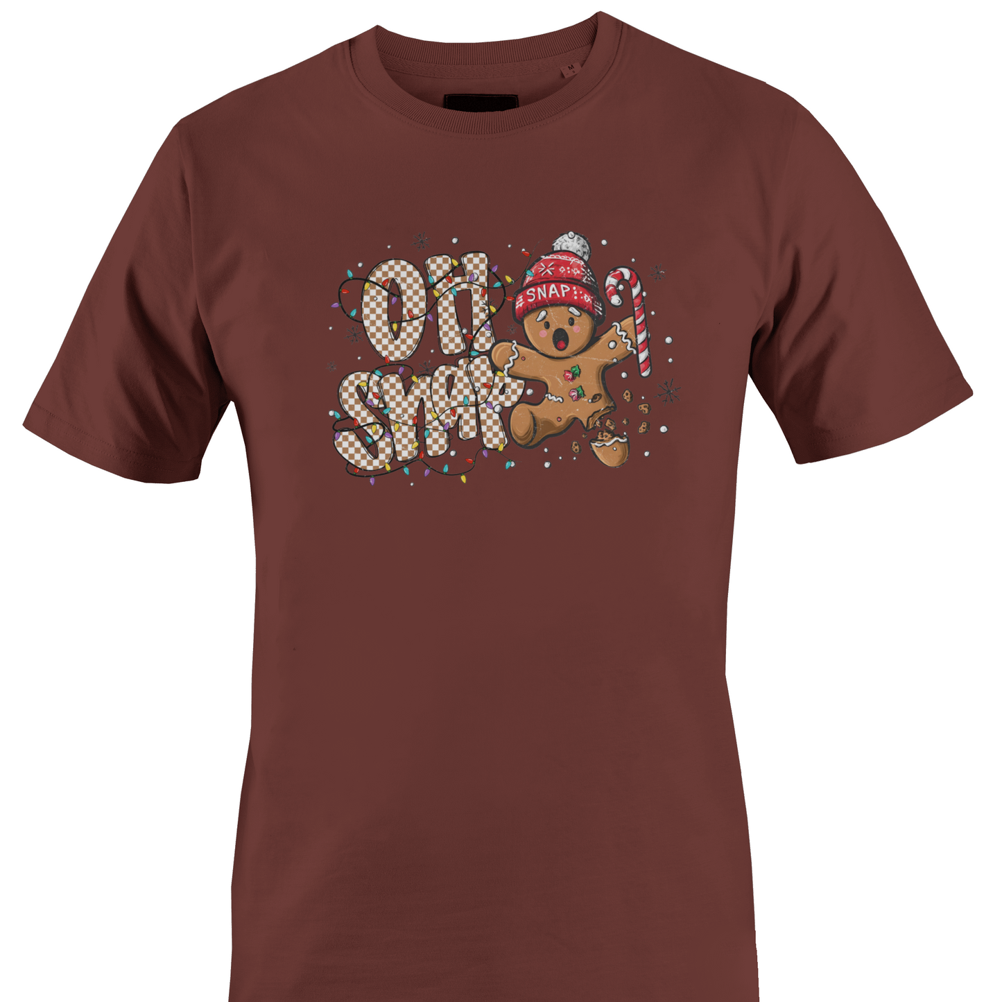 A brown short-sleeve crewneck t-shirt featuring a festive graphic on the chest with the text 'OH SNAP' in a patterned font, a gingerbread man wearing a red knit hat and holding a candy cane, and small snowflake details by Monkey's Creations.