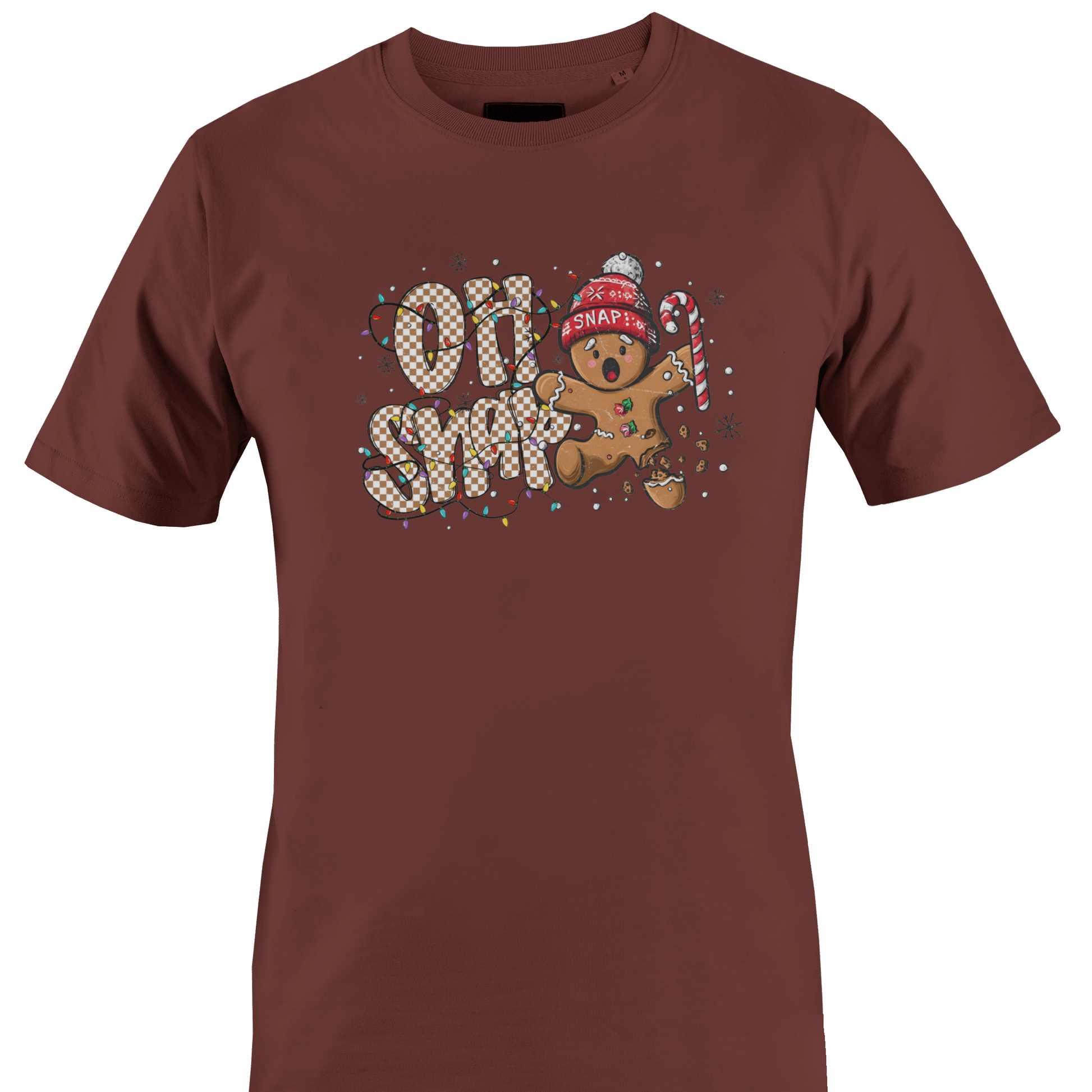 A brown short-sleeve crewneck t-shirt featuring a festive graphic on the chest with the text 'OH SNAP' in a patterned font, a gingerbread man wearing a red knit hat and holding a candy cane, and small snowflake details by Monkey's Creations.
