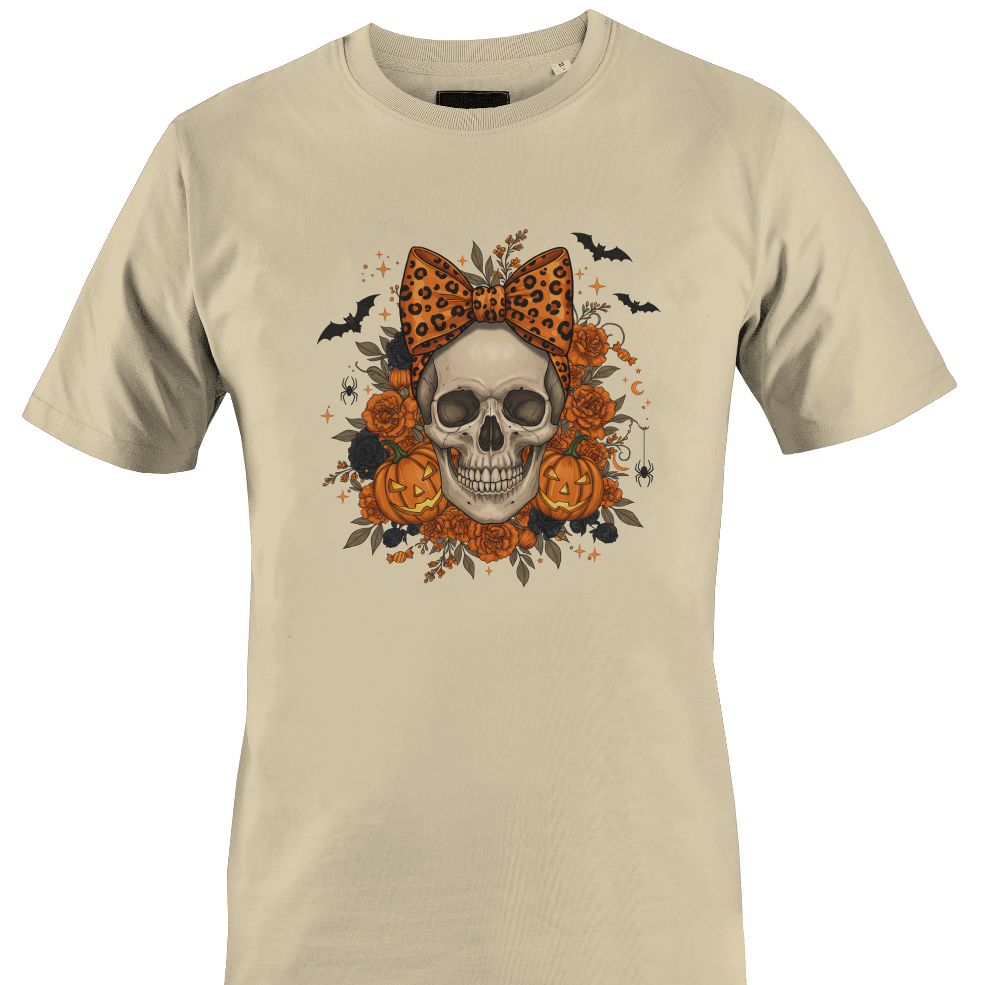 Tan t-shirt with a skull wearing an orange leopard print bow surrounded by black and orange roses and jack o lanterns for Halloween by Monkey's Creations. 