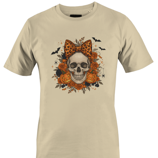 Tan t-shirt with a skull wearing an orange leopard print bow surrounded by black and orange roses and jack o lanterns for Halloween by Monkey's Creations. 