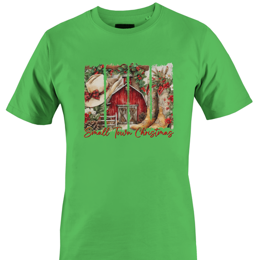Green t-shirt with a barn, cowboy hat and boots with the text "small town Christmas by Monkey's Creations. 