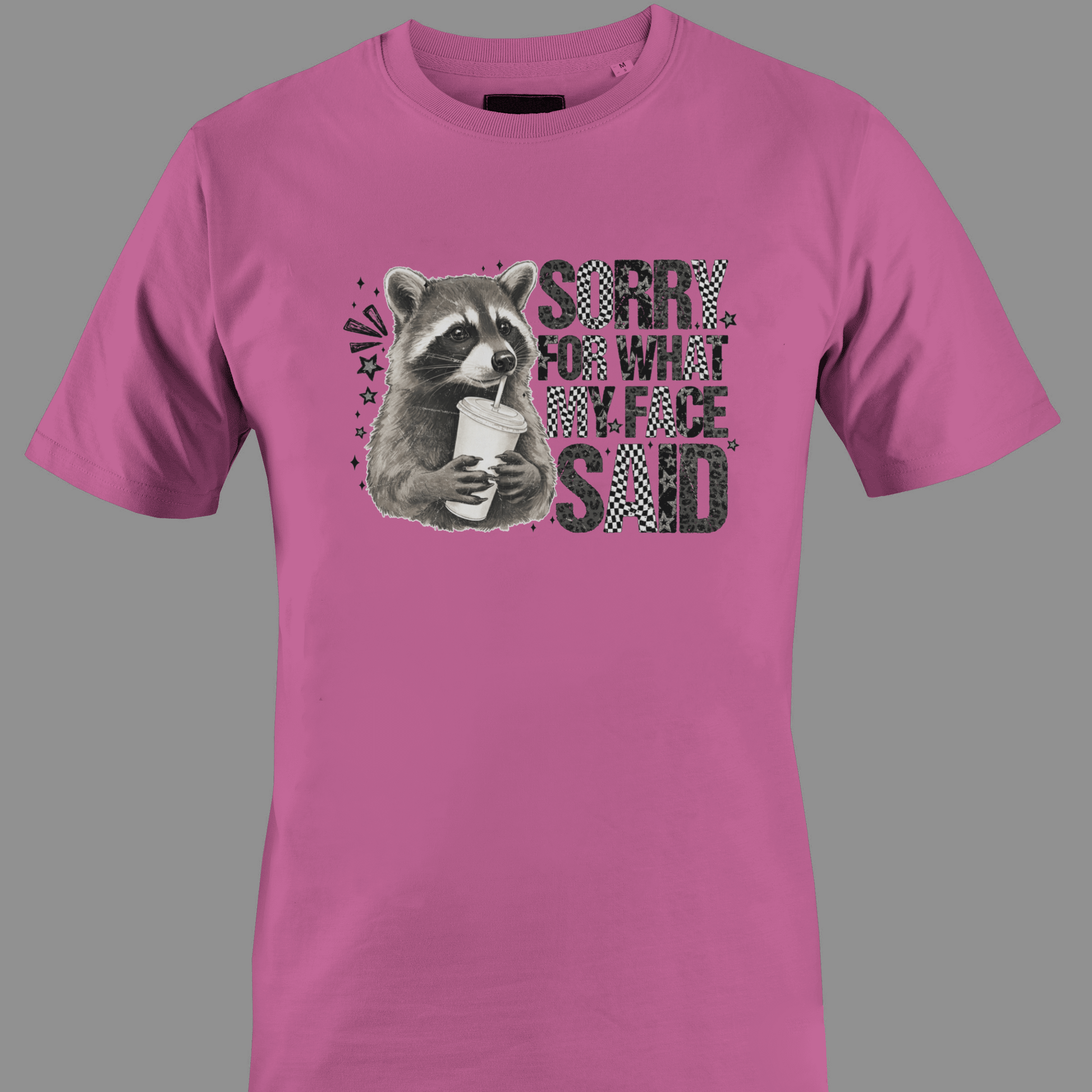 Dark pink t-shirt with a raccoon graphic and text sorry for what  my face said