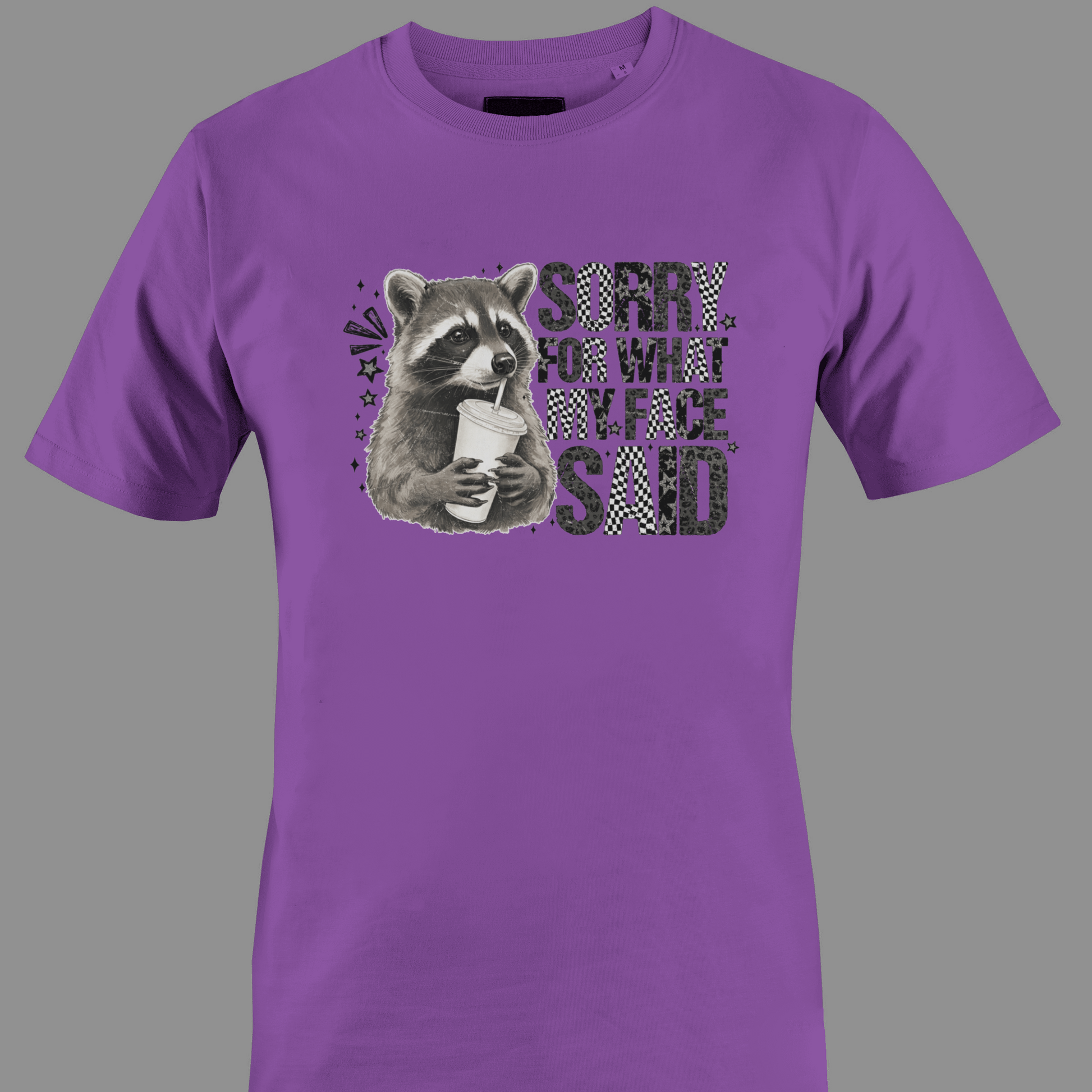 Purple t-shirt with a raccoon graphic and text sorry for what  my face said