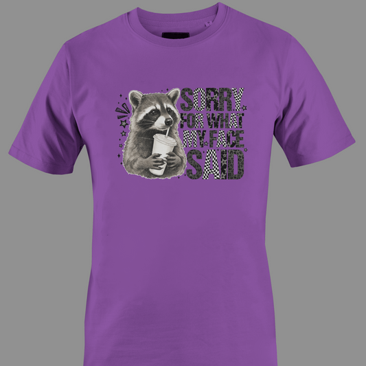 Purple t-shirt with a raccoon graphic and text sorry for what  my face said