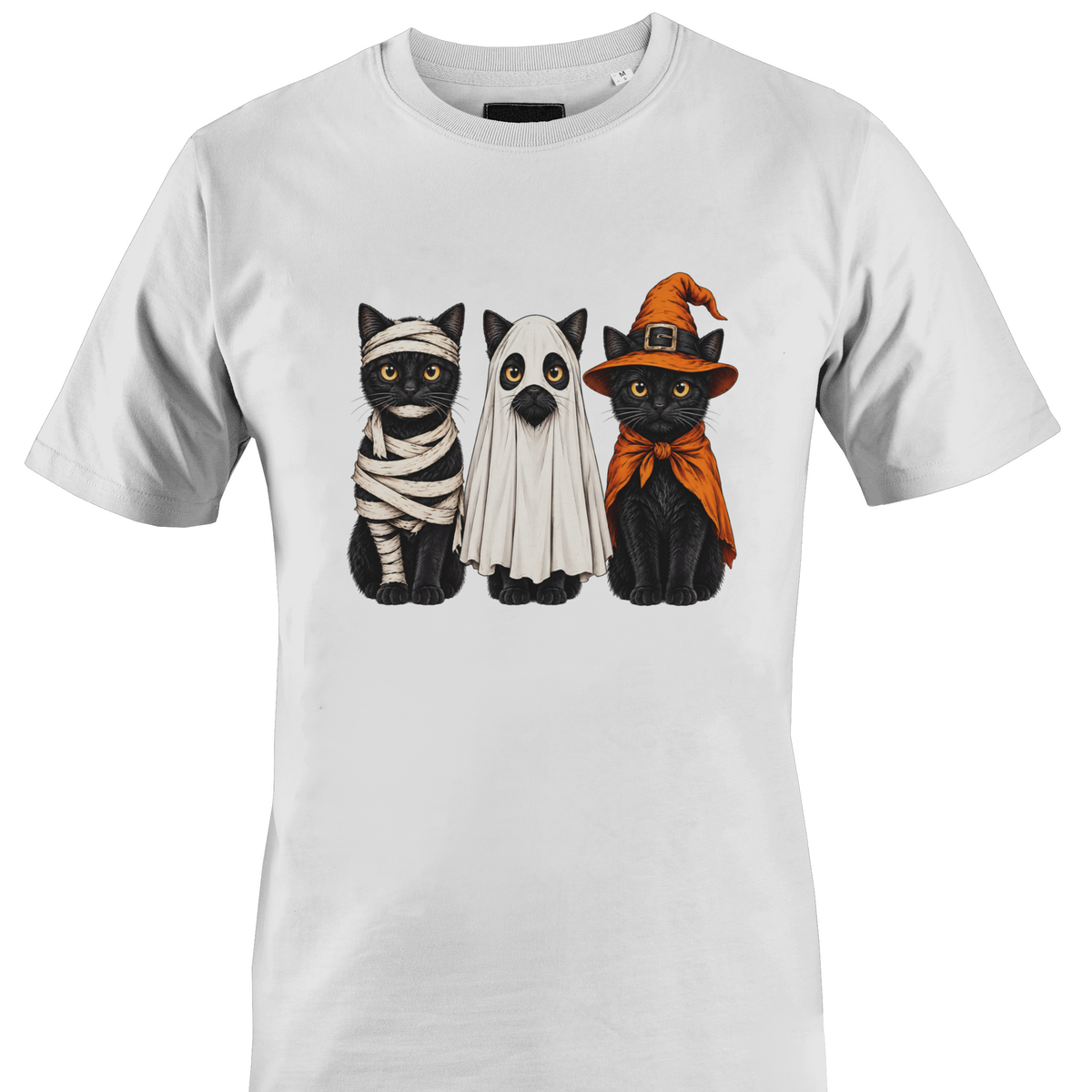 A white short-sleeve crewneck t-shirt featuring a graphic print of three black cats dressed in Halloween costumes (as a mummy, a ghost, and as a witch) by Monkey's Creations.