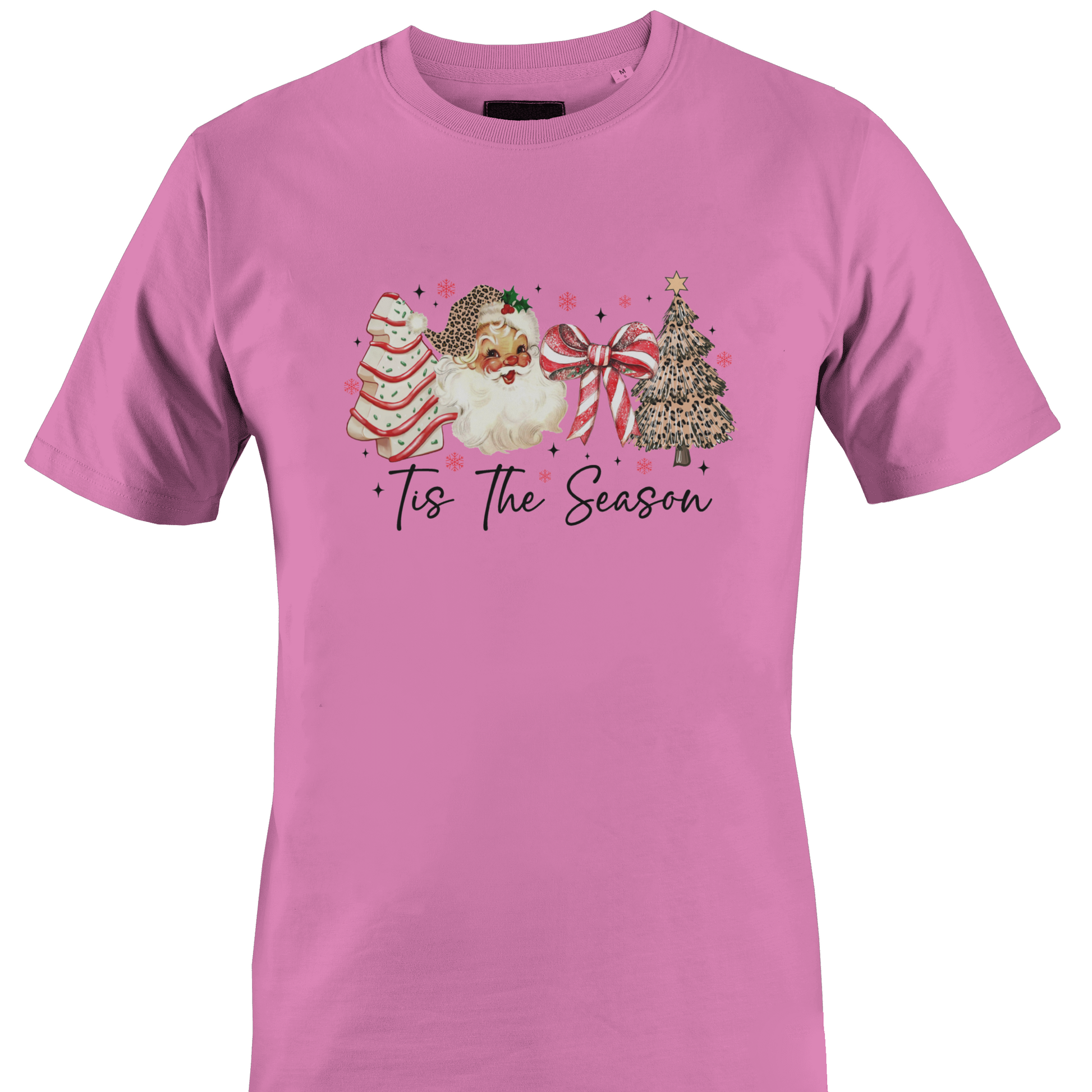 A dark pink short-sleeve crewneck t-shirt featuring a festive Christmas graphic on the chest. The graphic depicts a watercolor Santa Claus, a decorated Christmas tree, a striped ornament, and a large red bow, with the text 'Tis The Season' written below in a black script font by Monkey's Creations.