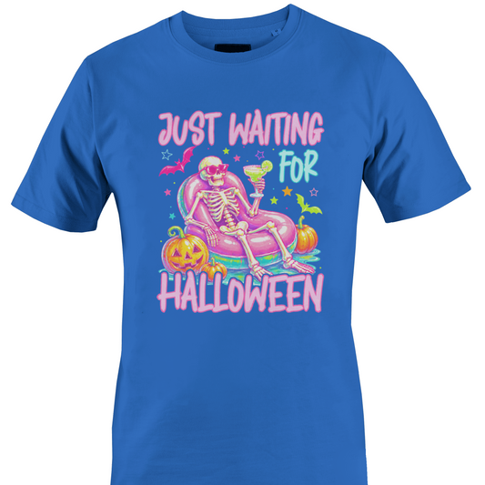 Blue t-shirt with a colorful skeleton on a pool floatie with Halloween elements and text 'Just Waiting for Halloween' by Monkey's Creations. 