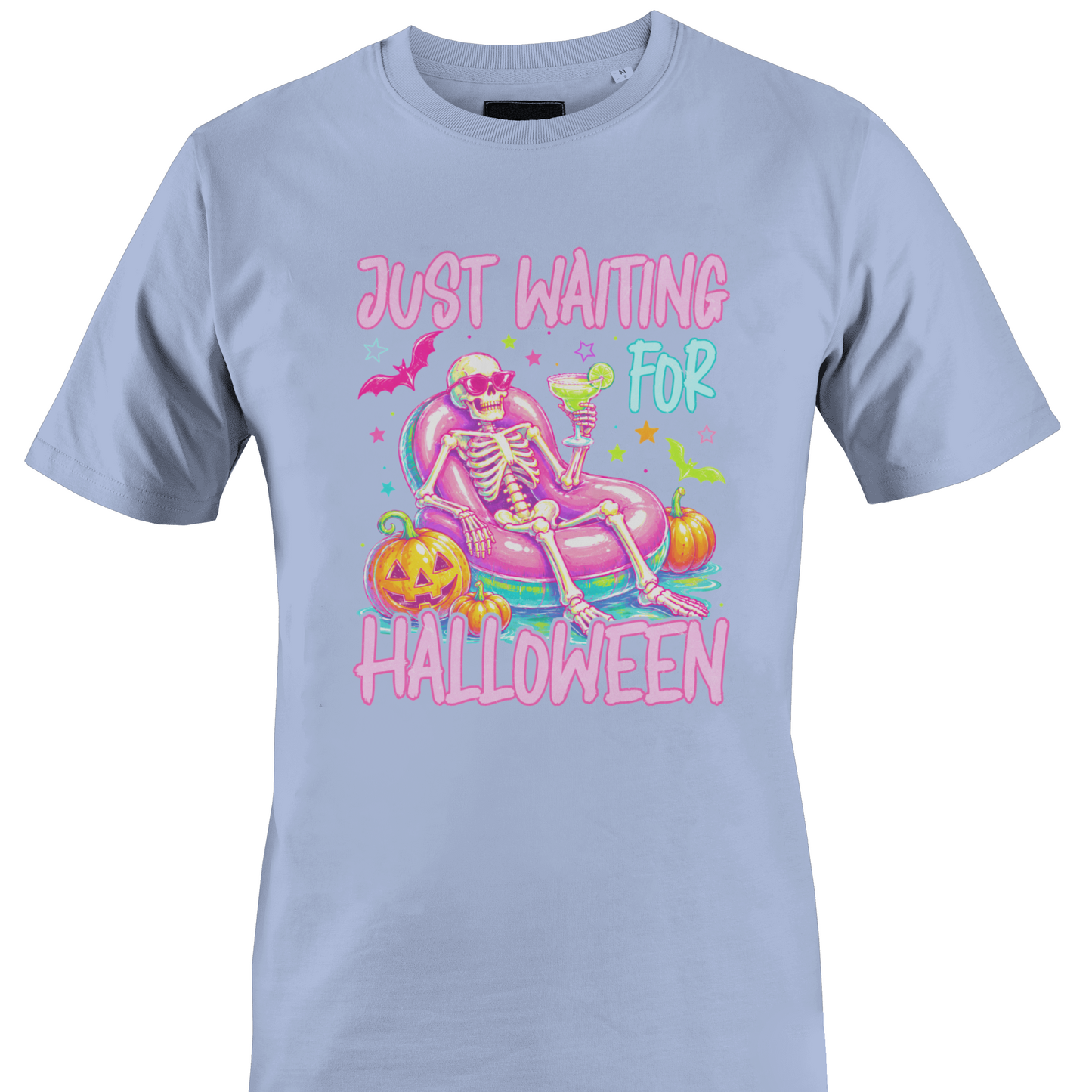 Light blue t-shirt with a colorful skeleton on a pool floatie with Halloween elements and text 'Just Waiting for Halloween' by Monkey's Creations. 