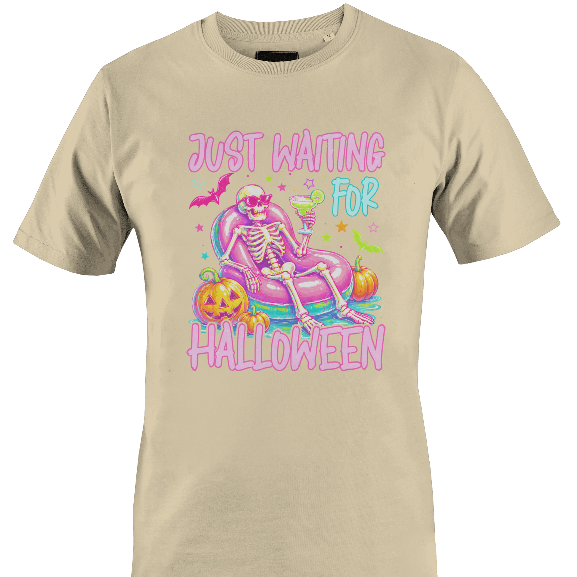 Tan t-shirt with a colorful skeleton on a pool floatie with Halloween elements and text 'Just Waiting for Halloween' by Monkey's Creations. 