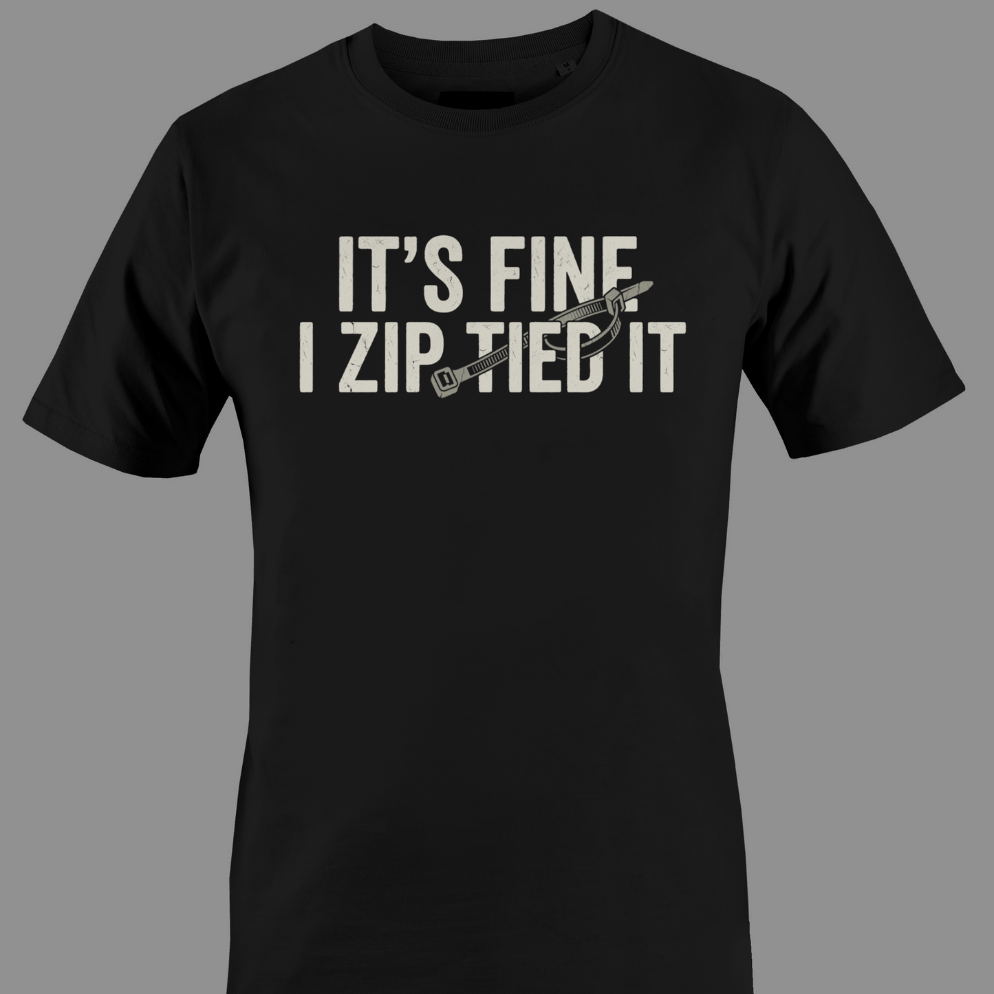 Black t-shirt with white text 'IT'S FINE I ZIP TIED IT' 