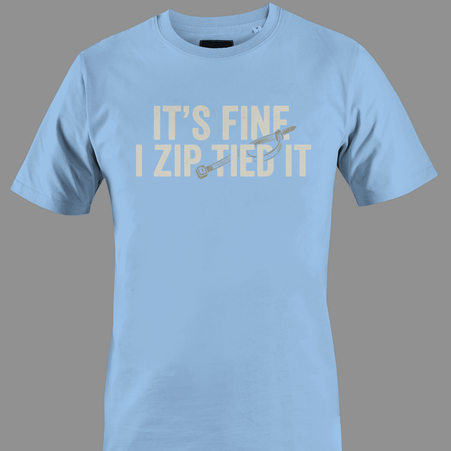 Light Blue t-shirt with white text 'IT'S FINE I ZIP TIED IT' 