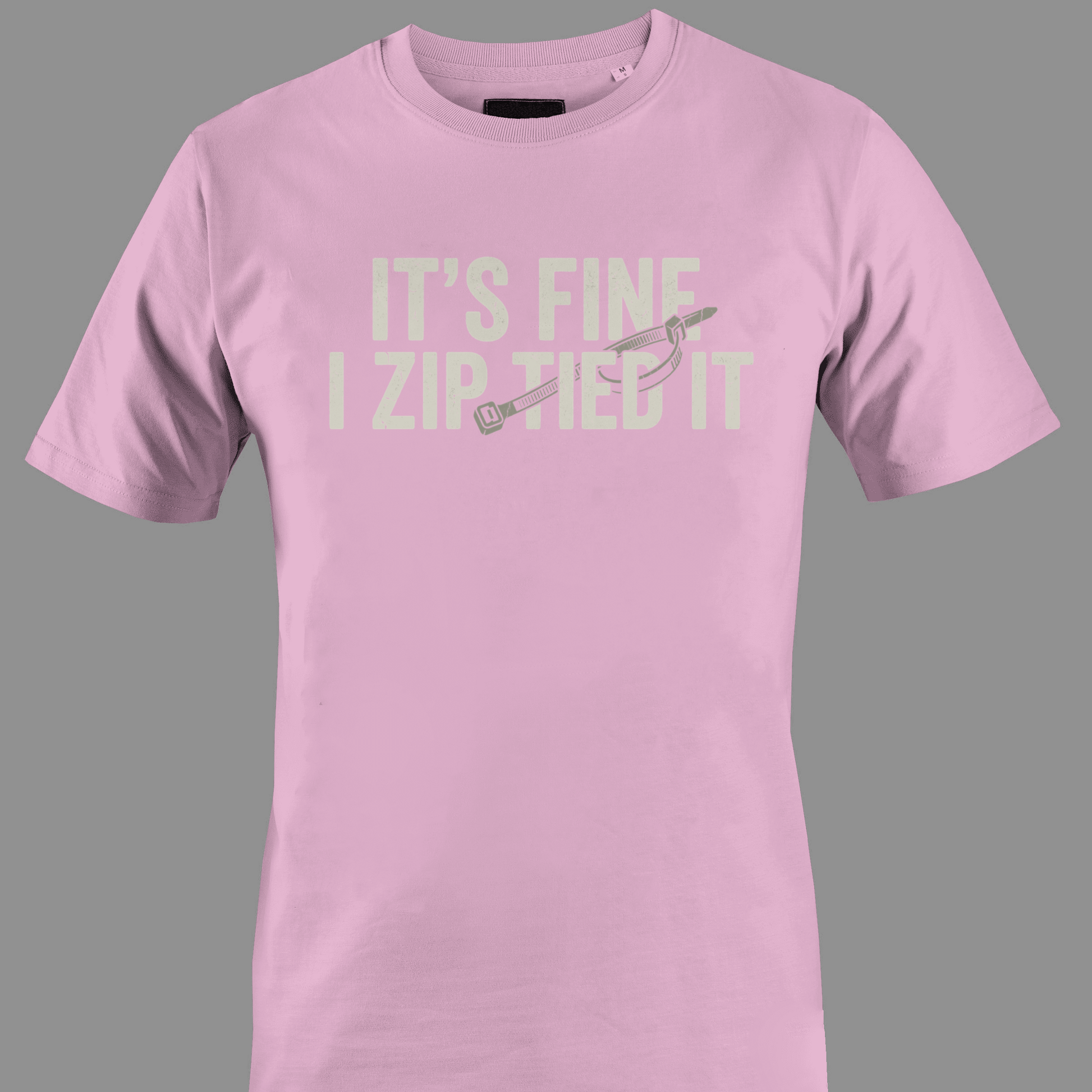 Light pink t-shirt with white text 'IT'S FINE I ZIP TIED IT' 