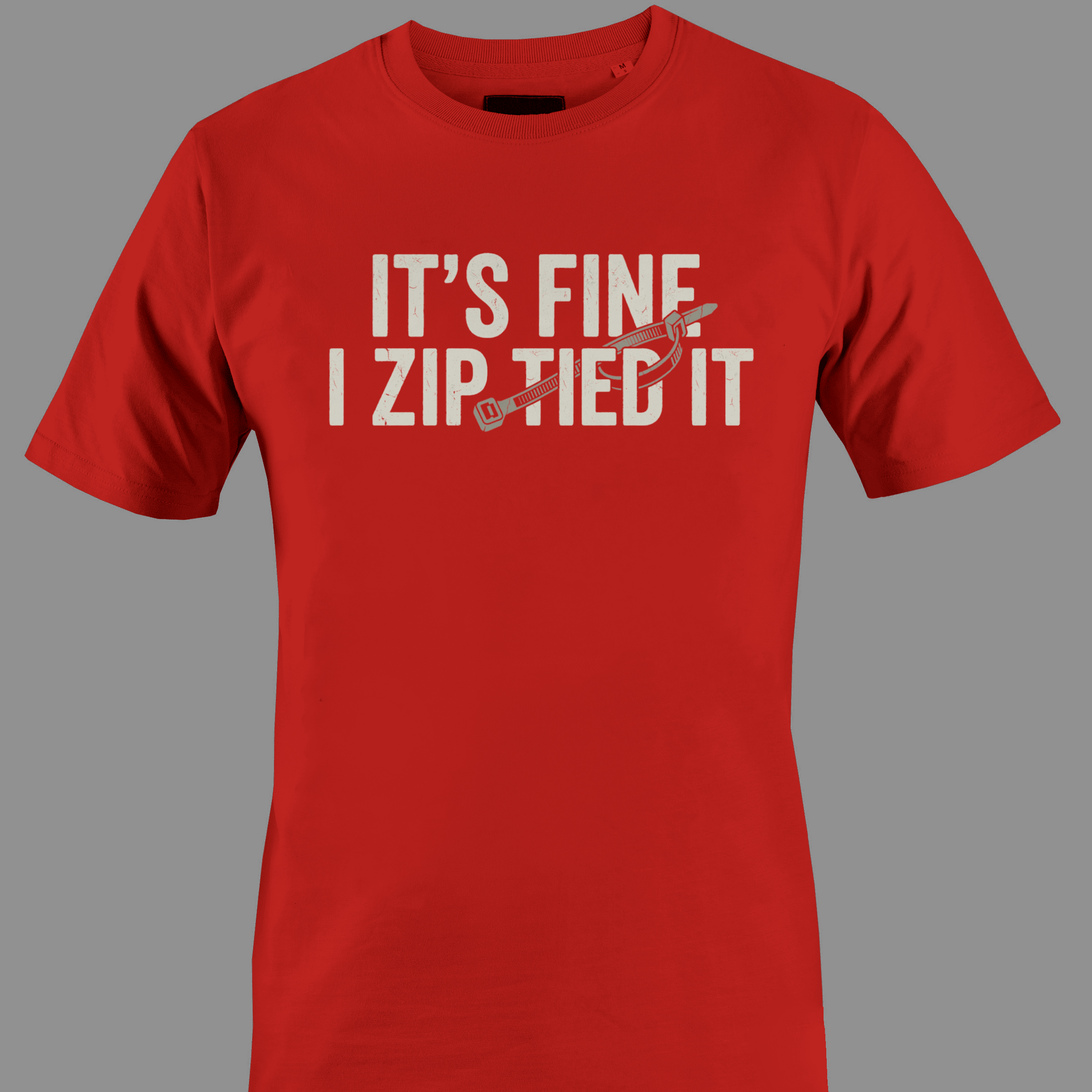 Red t-shirt with white text 'IT'S FINE I ZIP TIED IT' 