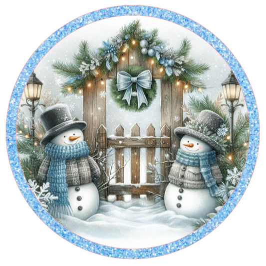 Round metal wreath sign with a blue themed snowman couple and winter elements by Monkey's Creations.