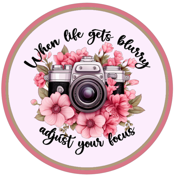 Flowers and a camera, featuring text 'When life gets blurry adjust your focus' 