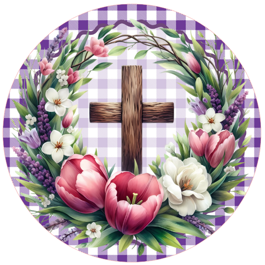 Round metal wreath sign with flowers and a wooden cross on a checkered background