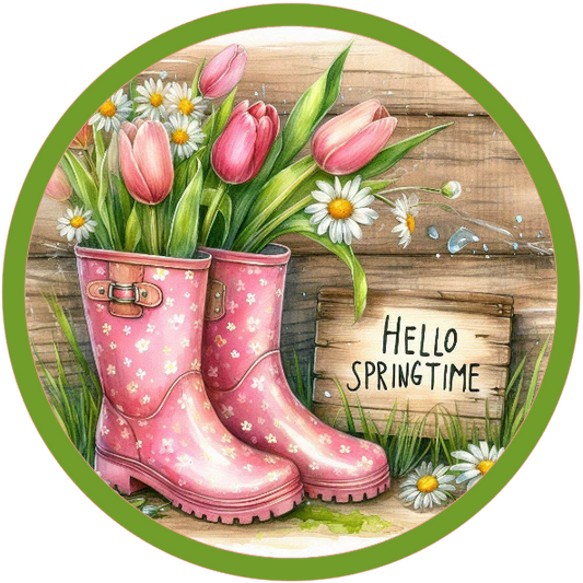 Round metal wreath sign with pink rain boots with tulips and daisies with 'Hello Springtime' text.