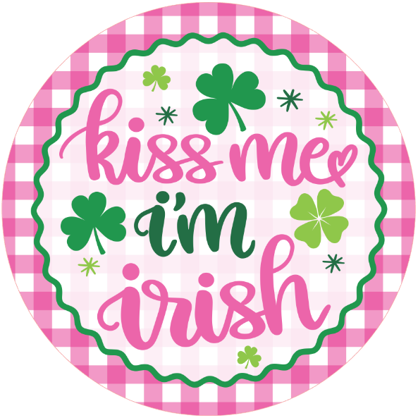 Round metal wreath sign with 'kiss me I'm Irish' text and shamrock symbols on a pink checkered border.