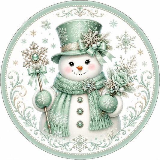 Round metal wreath sign featuring a mint green bejeweled snowman by Monkey's Creations. 