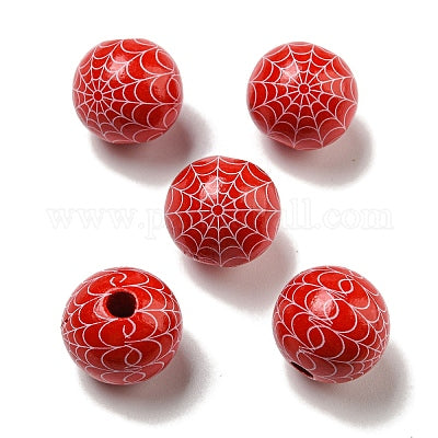 Painted orange wooden beads with white cobwebs for crafting and wreath making. 