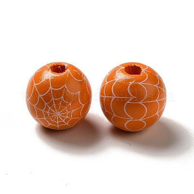 Painted orange wooden beads with white spider webs for crafting and wreath making 