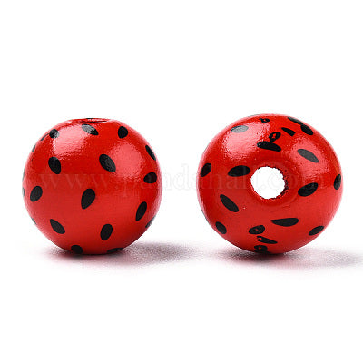 Painted red wooden bead with black seeds imitating a watermelon for crafting and wreath making