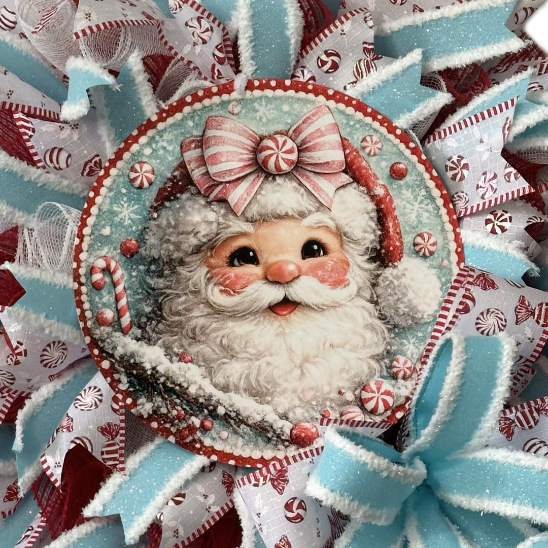 Deco mesh and ribbon wreath by Monkey's Creations featuring a peppermint candy themed light blue, red and white Santa Claus for Christmas