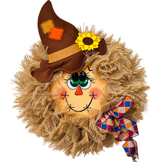 Deco mesh and ribbon scarecrow wreath featuring a scarecrow face wreath center, a brown hat, light brown (natural) frayed edge burlap deco mesh and a farmhouse inspired check ribbon bow by Monkey's Creations. 