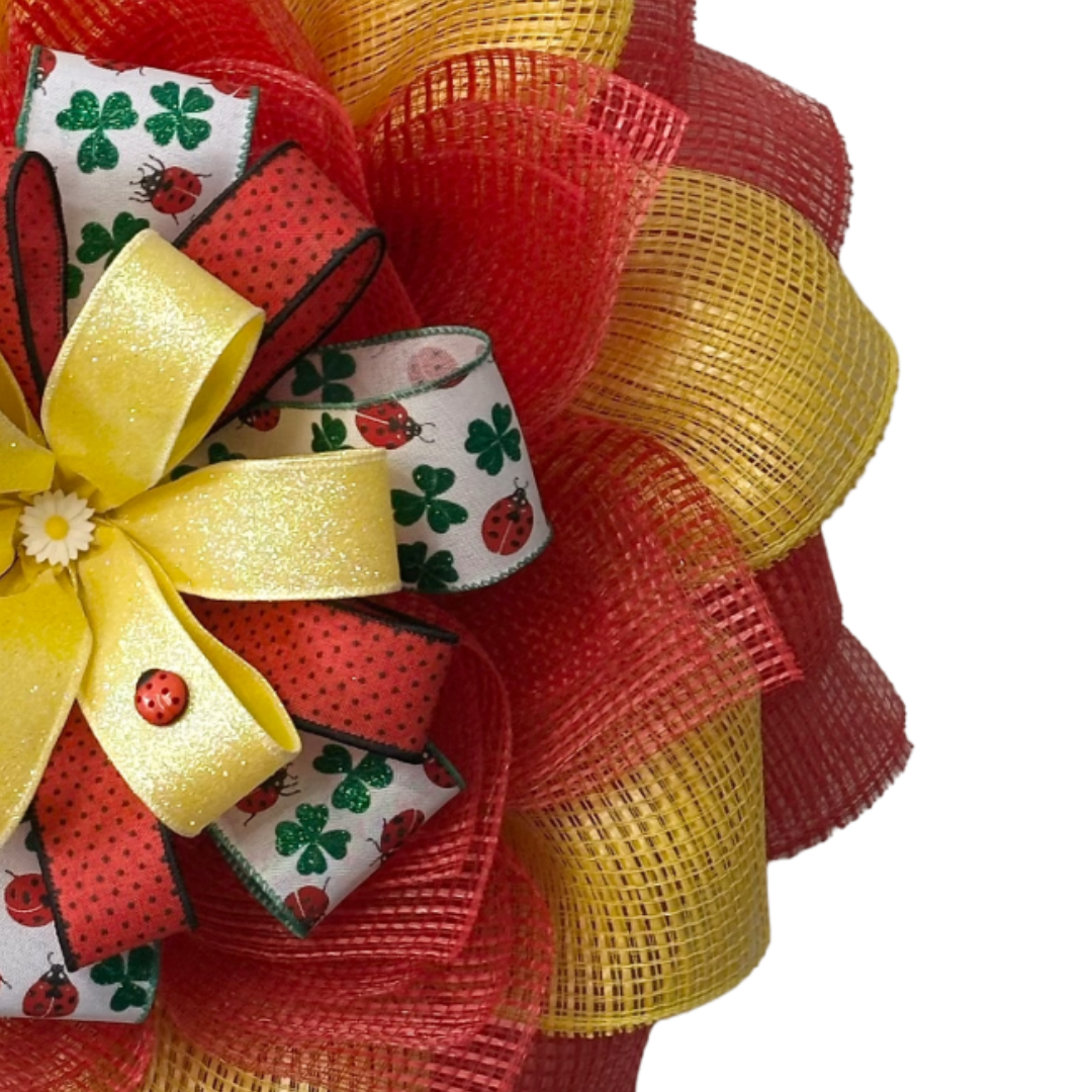 Red and yellow deco mesh flower wreath with a ribbon center and spring elements by Monkey's Creations