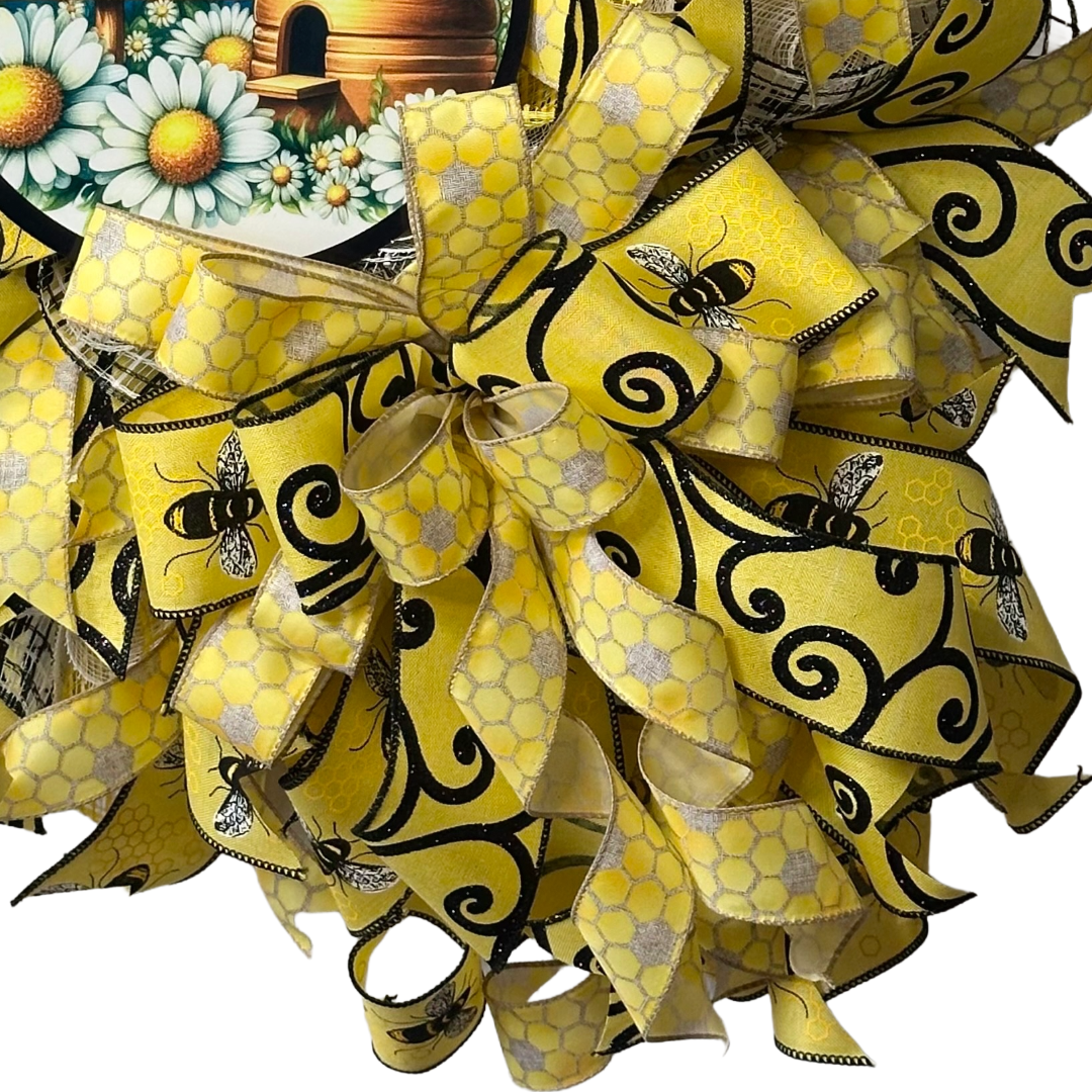 Deco mesh and ribbon wreath with yellow and black bee design, featuring a 'Welcome to Our Hive' wreath sign designed by Monkey's Creations.