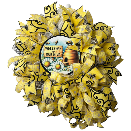 Deco mesh and ribbon wreath with yellow and black bee design, featuring a 'Welcome to Our Hive' wreath sign designed by Monkey's Creations.