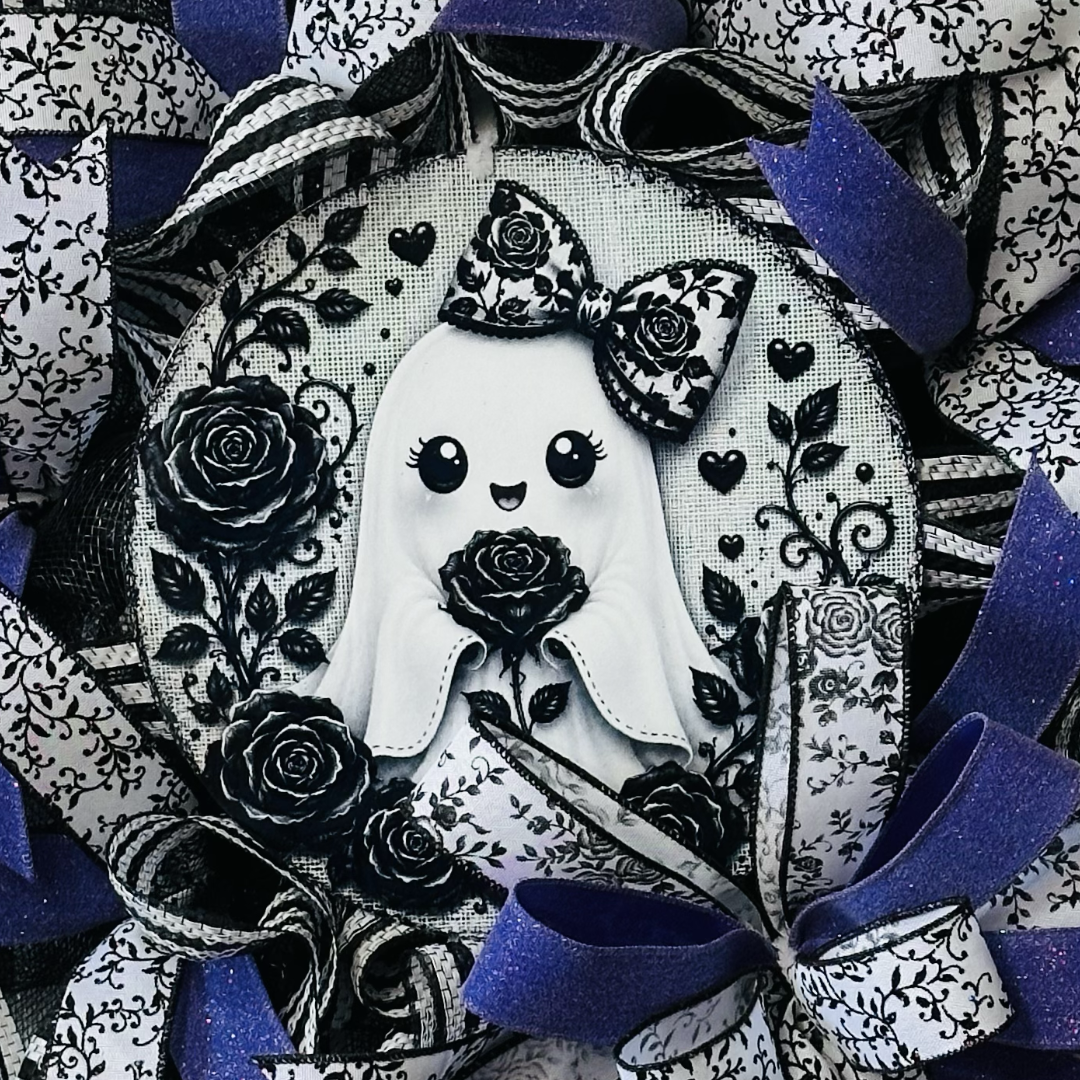 A deco mesh and ribbon wreath featuring a cute ghost with roses metal wreath sign black and white deco mesh and ribbon with purple ribbon by Monkey's Creations. 