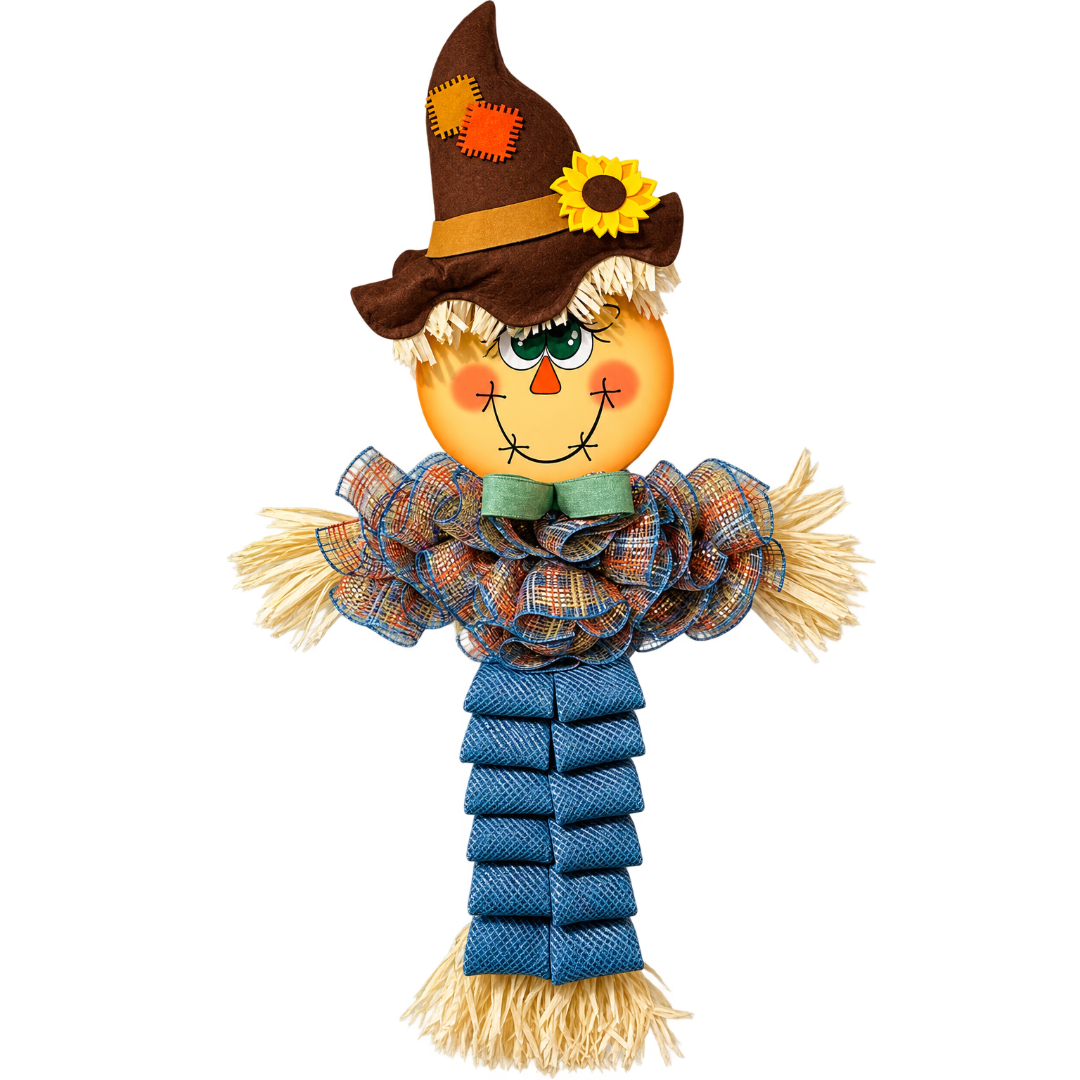 A decorative deco mesh autumn scarecrow door hanger with a round character face, brown hat with a yellow flower, rafia accents, an orange and smoke blue plaid shirt and smoke blue pants by Monkey's Creations. 